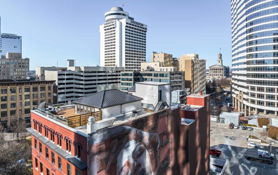 Cityscape with a mix of modern and historic buildings under a clear sky.