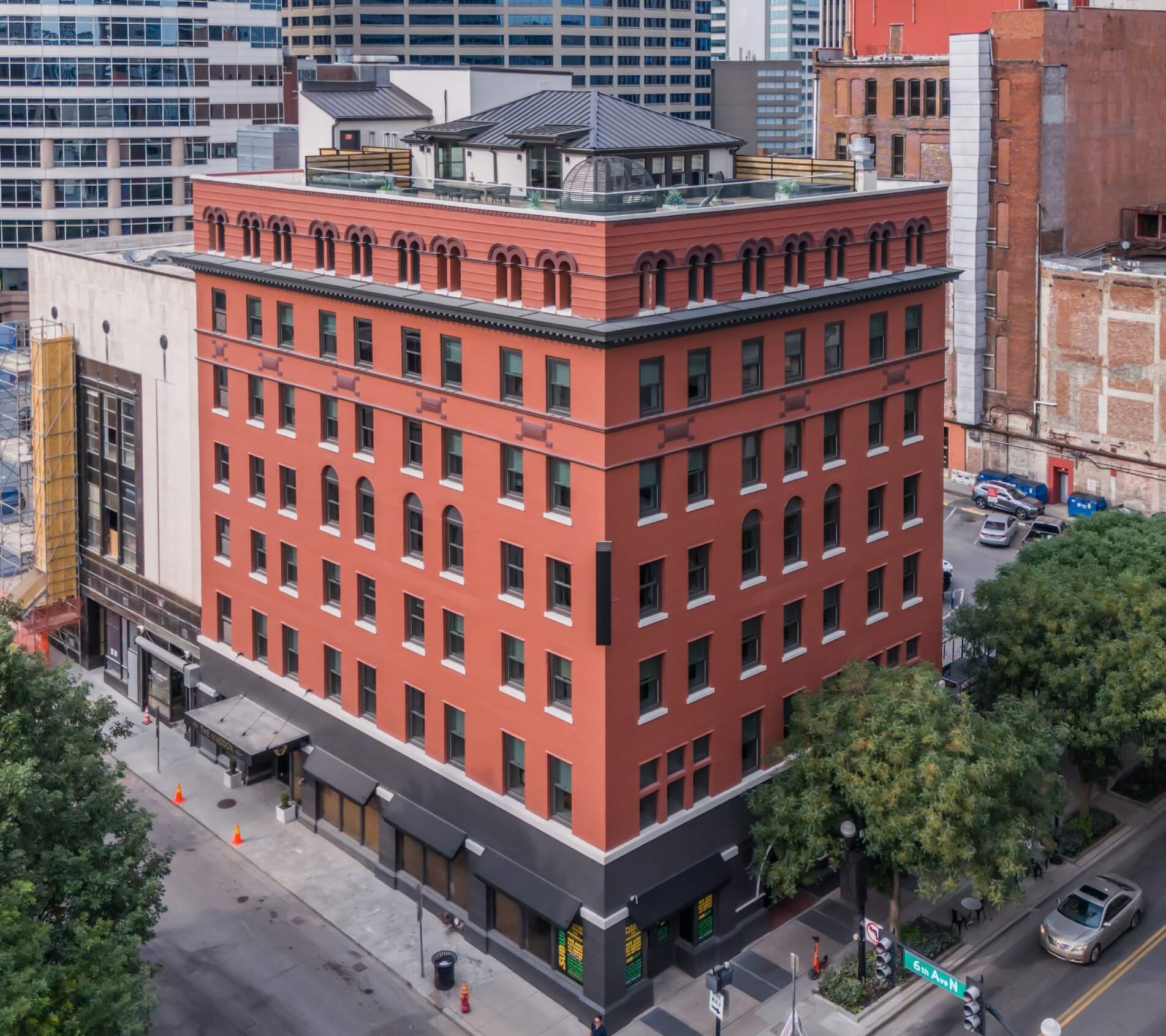 Aerial view of a red brick building in an urban setting.